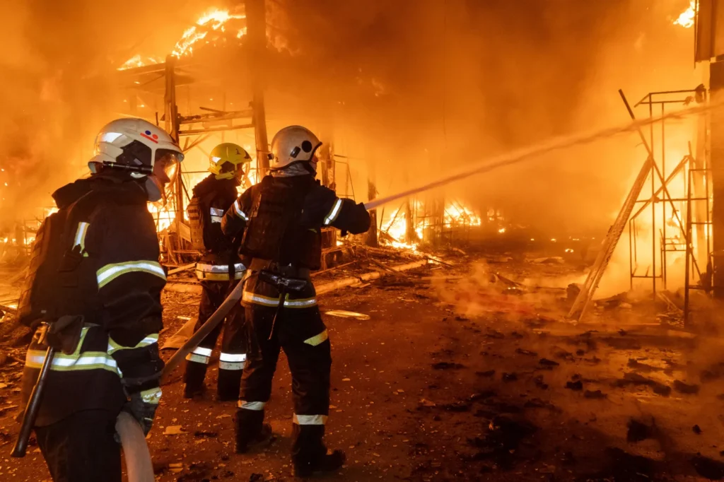 Firefighters tackle the blaze after a Russian air attack that hit at Barabashovo market in Kharkiv, Ukraine, Wednesday, Oct. 1, 2025.
