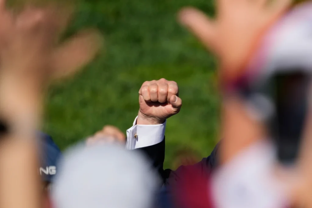 President Donald Trump pumps his fist as he greets the crowd at the Ryder Cup golf tournament, Friday, Sept. 26, 2025, on the Bethpage Black golf course in Farmingdale, N.Y