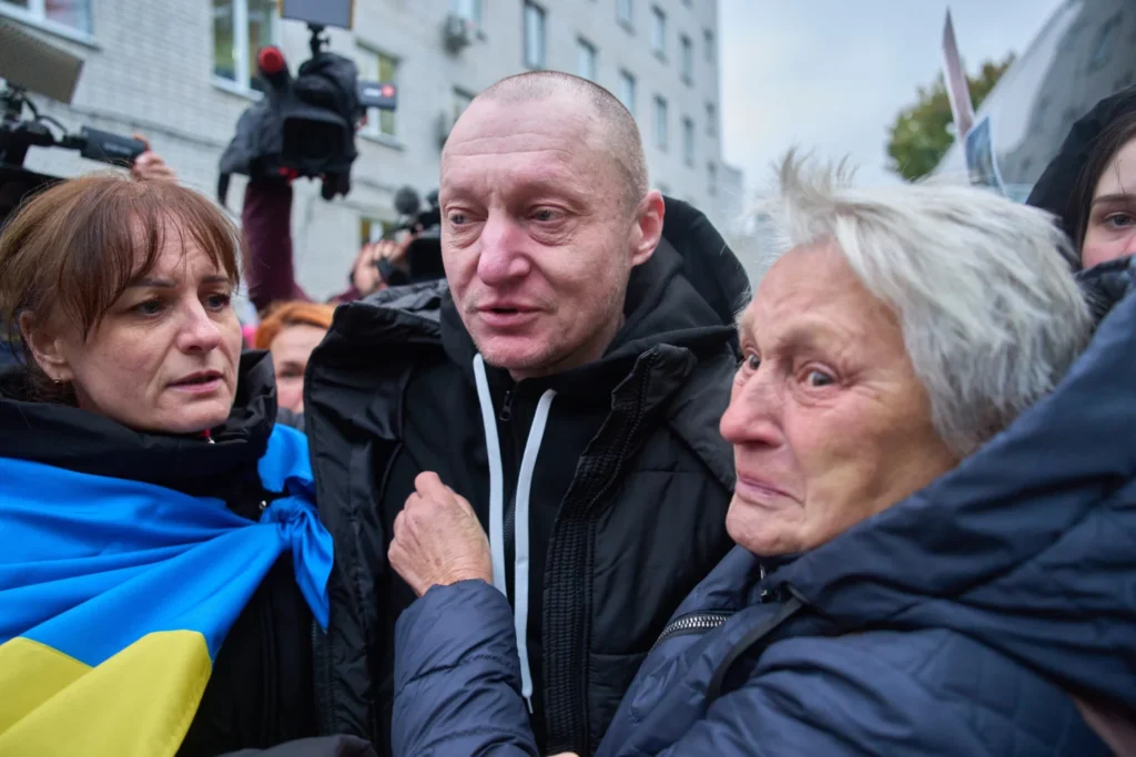 A mother holds her son soldier as he returns from Russian captivity during a POW exchange between Russia and Ukraine in Chernyhiv region, Ukraine, Thursday, Oct, 2025.