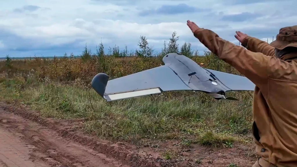  In this photo taken from video distributed by Russian Defense Ministry Press Service on Tuesday, Sept. 30, 2025, A Russian soldier launches a drone for an action in an undisclosed location in Ukraine