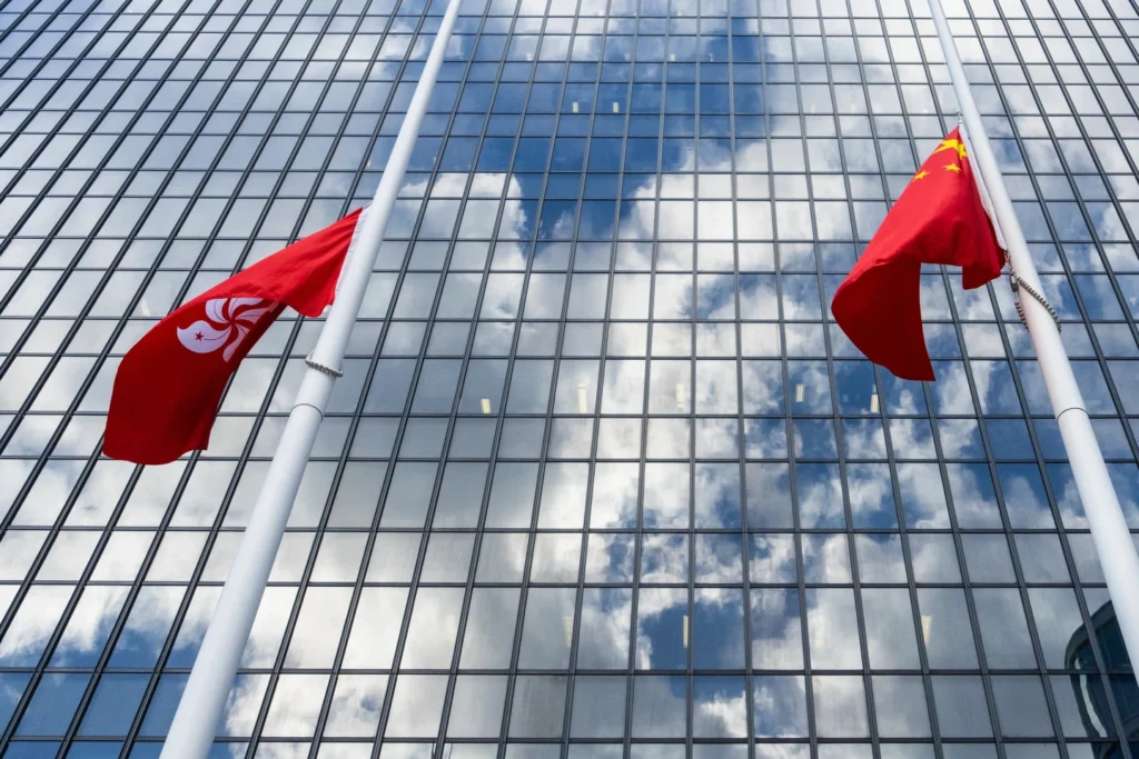 Chinese and Hong Kong Special Administration Region flags fly at half-mast to mourn the victims of the deadly fire that started Wednesday at Wang Fuk Court