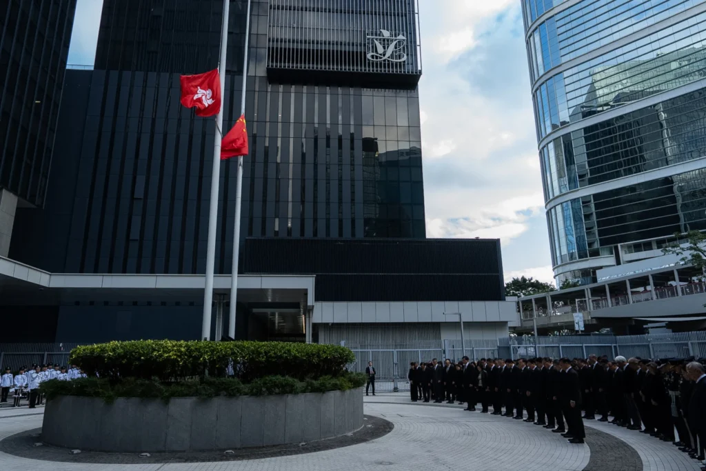 Chinese and Hong Kong Special Administration Region flags fly at half-mast to mourn the victims of the deadly fire that started Wednesday at Wang Fuk Court