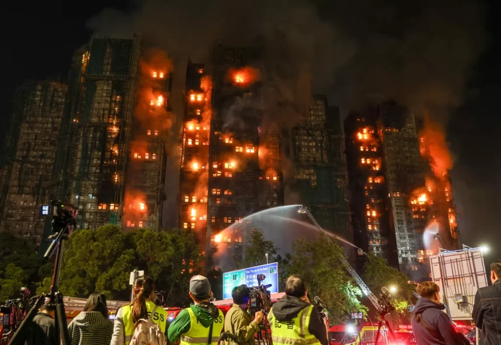 Firefighters tackle a fire engulfing residential buildings at Wang Fuk Court in the Tai Po district of Hong Kong on Wednesday