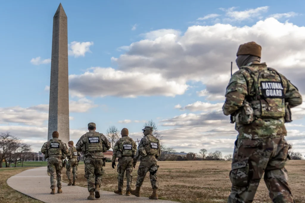 National Guardsmen patrol in front of the Washington Monument on the National Mall