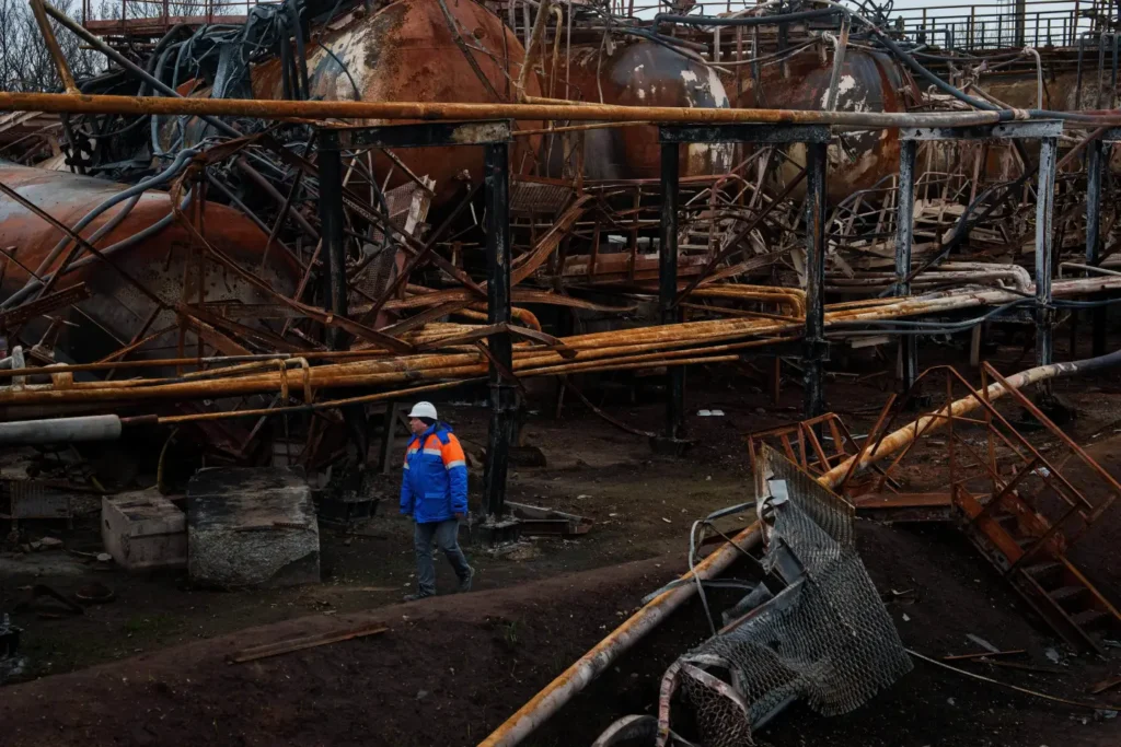Victor walks in front of a Naftogaz gas extraction facility destroyed by a Russian strike in Ukraine