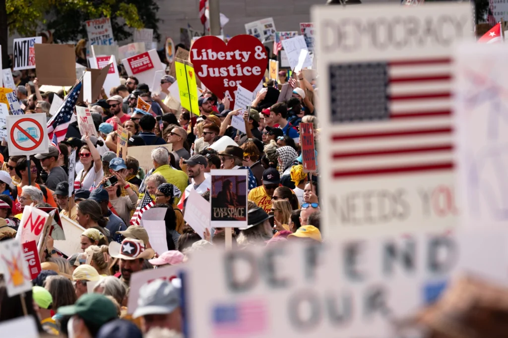 Demonstrators rally on Pennsylvania Avenue during a No Kings protest in Washington, Oct. 18, 2025