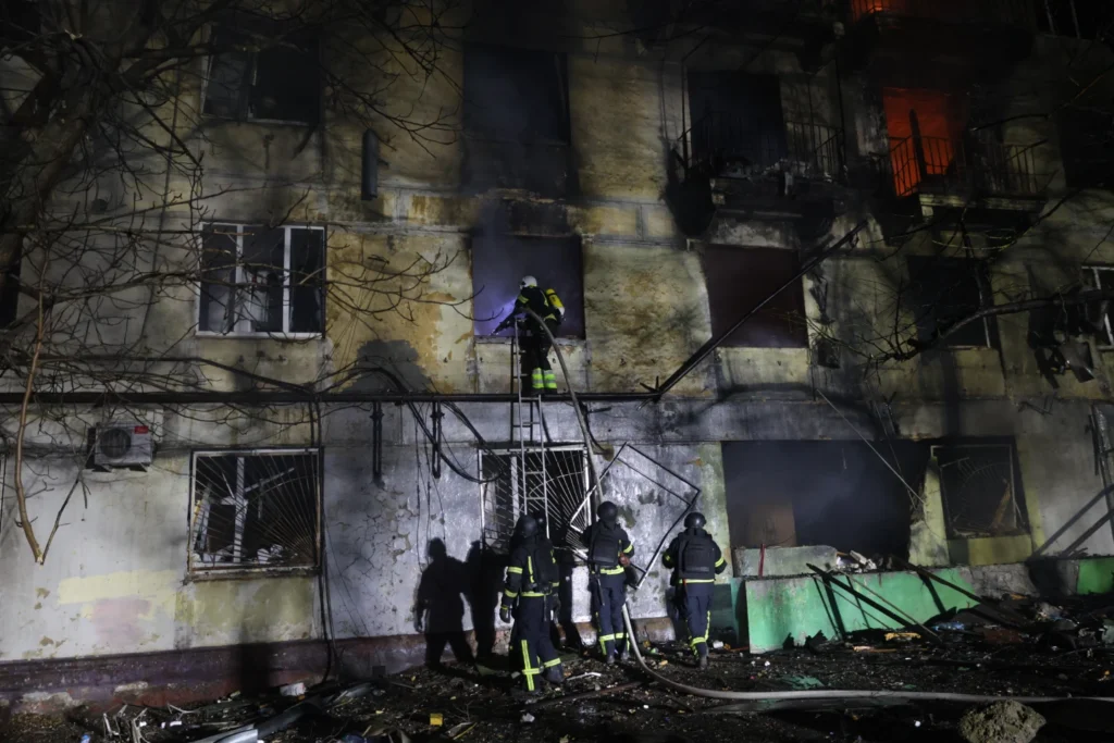 Rescue workers try to put out a fire of residential building burning after a Russian attack on Zaporizhzhia, Ukraine