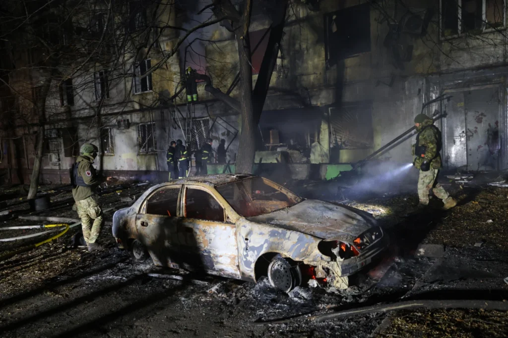 Rescue workers try to put out a fire of residential building burning after a Russian attack on Zaporizhzhia, Ukraine