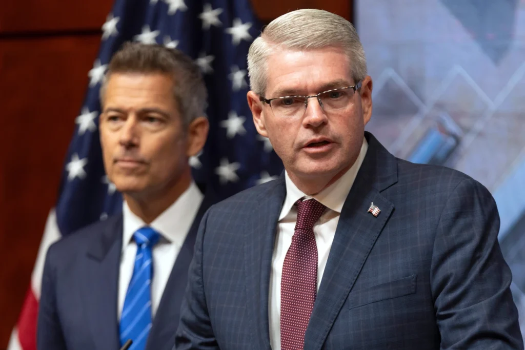 Transportation Secretary Sean Duffy and Darek Barrs, Administrator of the Federal Motor Carrier Safety Administration, listen during a news conference at the Department of Transportation in Washington