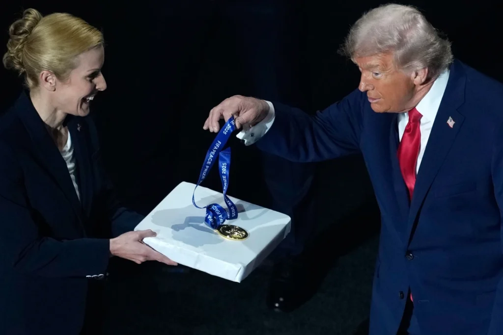 President Donald Trump is presented with the inaugural FIFA Peace Prize by FIFA President Gianni Infantino during the 2026 FIFA World Cup draw at the Kennedy Center in Washington