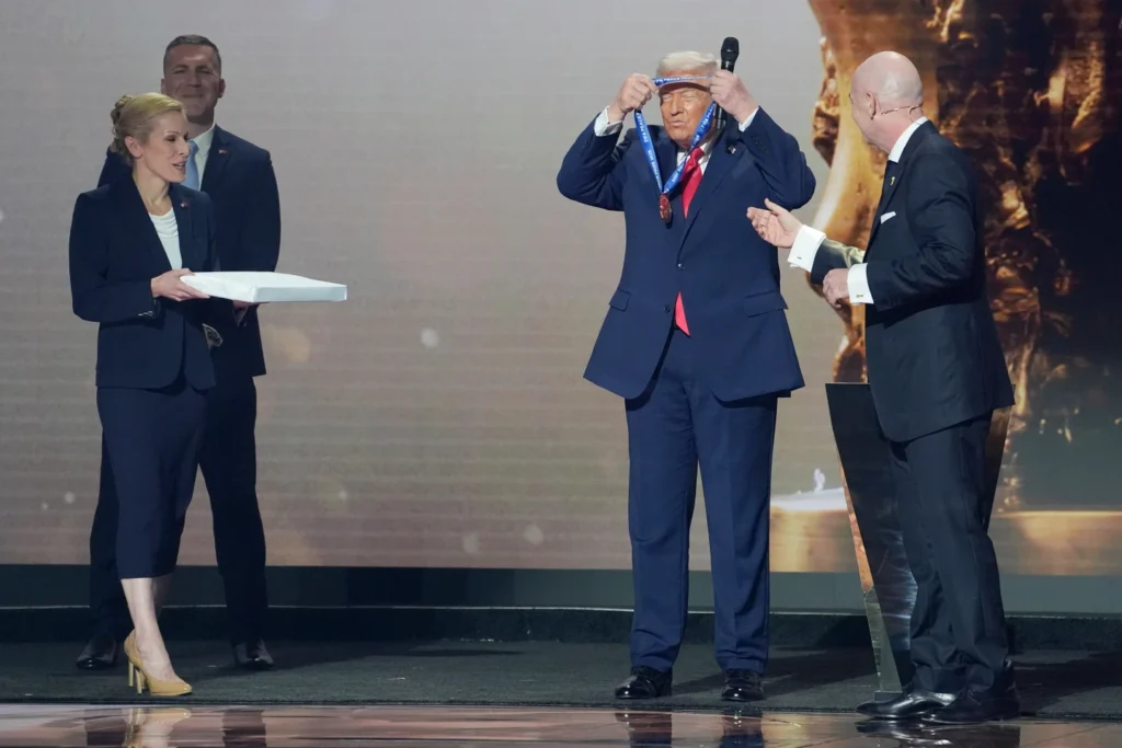 President Donald Trump is presented with the inaugural FIFA Peace Prize by FIFA President Gianni Infantino during the 2026 FIFA World Cup draw at the Kennedy Center in Washington 