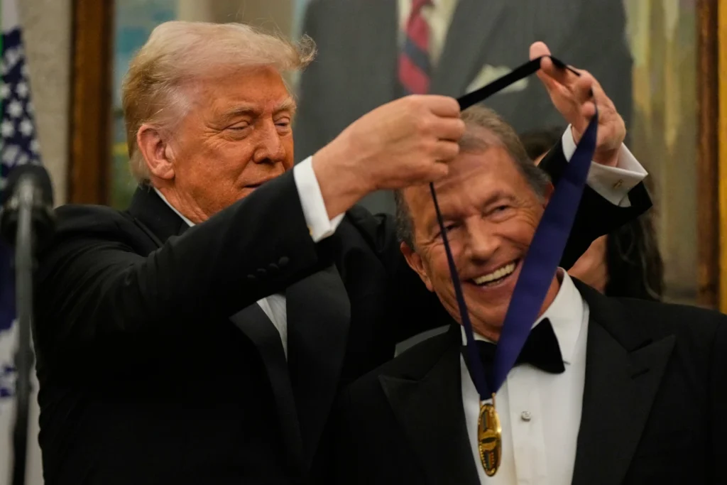 President Donald Trump presents George Strait with his Kennedy Center Honors medal in the Oval Office reception of White House in Washington