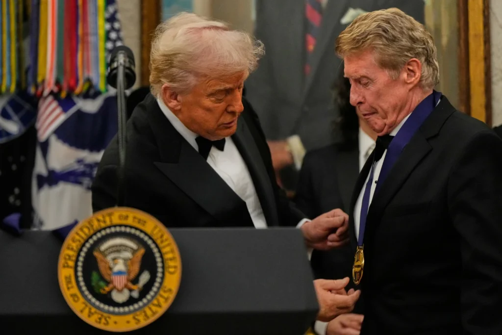 President Donald Trump presents Michael Crawford with his Kennedy Center Honors medal in the Oval Office reception of White House in Washington