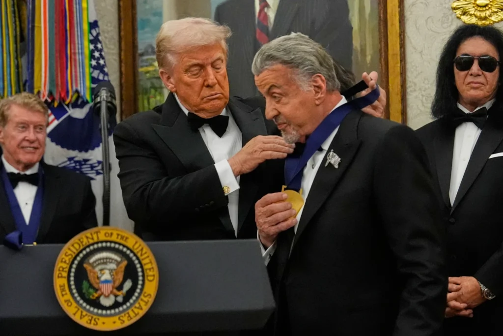 President Donald Trump presents Sylvester Stallone with his Kennedy Center Honors medal in the Oval Office reception of White House in Washington