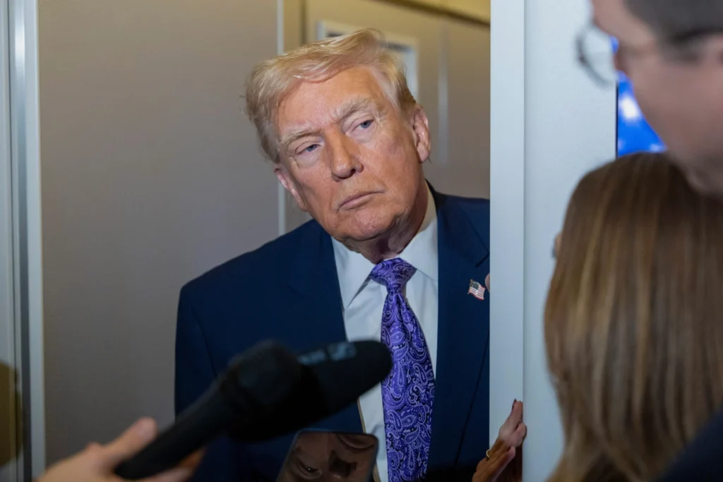 President Donald Trump speaks with reporters while in flight on Air Force One from his Mar-a-Lago estate in Palm Beach, Fla., to Joint Base Andrews, Sunday, Nov. 30,2025