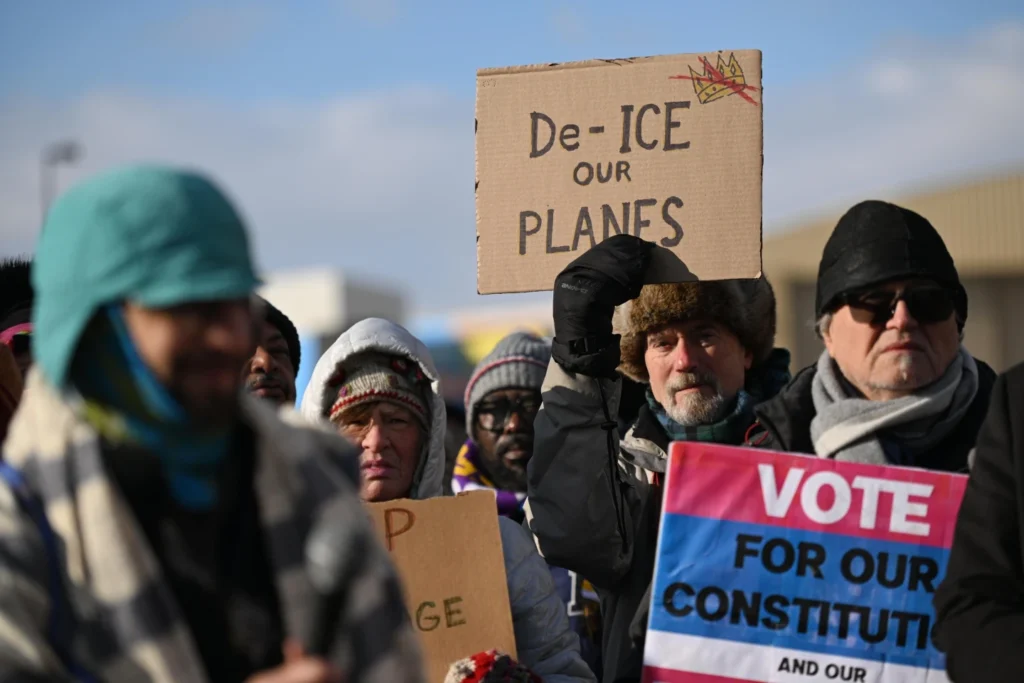 Protestors gather at a rally for immigrant and worker outside Signature Aviation near the Minneapolis-Saint Paul International Airport in Minneapolis