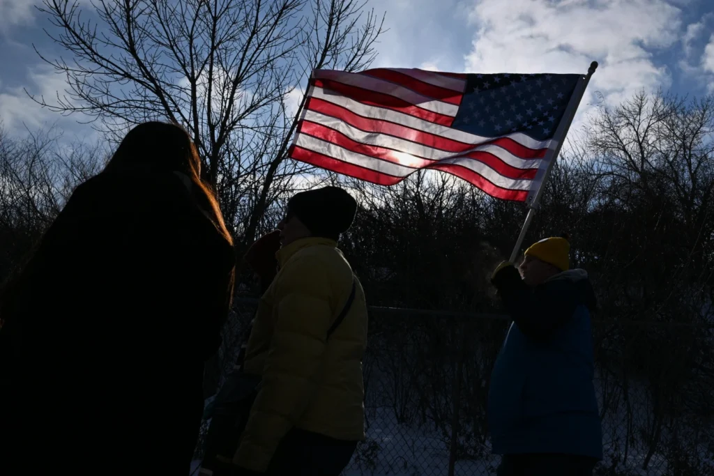 Protestors gather at a rally for immigrant and worker outside Signature Aviation near the Minneapolis-Saint Paul International Airport in Minneapolis
