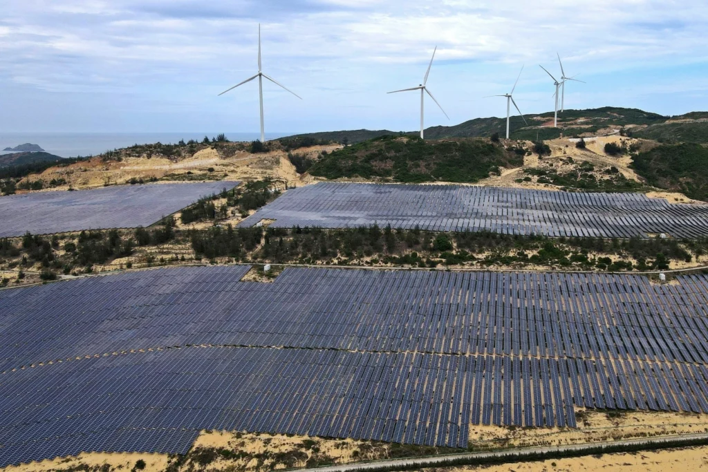 Solar panels work near wind turbines in Quy Non, Vietnam