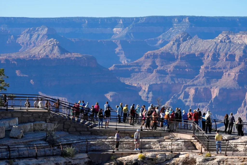 Tourists flock to Mather Point at Grand Canyon National Park in Grand Canyon, Ariz