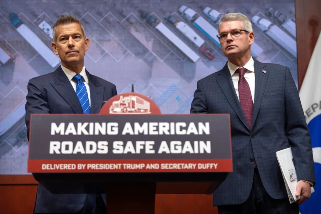 Transportation Secretary Sean Duffy and Darek Barrs, Administrator of the Federal Motor Carrier Safety Administration, listen during a news conference at the Department of Transportation in Washington
