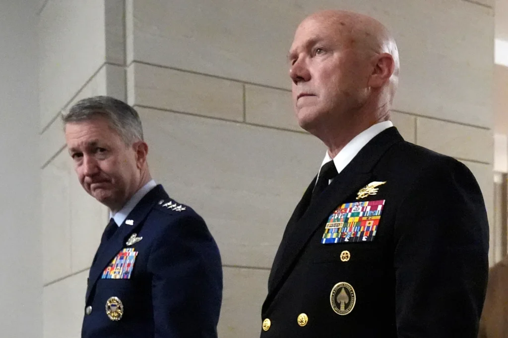 U.S. Navy Adm. Frank M. Bradley, accompanied by Gen. Dan Caine, chairman of the Joint Chiefs of Staff walks to a meeting with senators on Capitol Hill in Washington